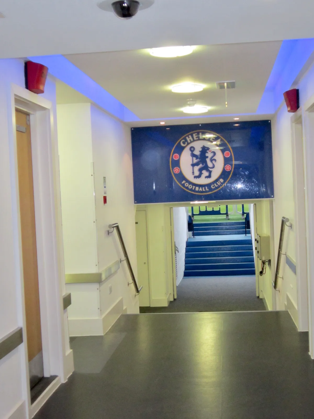 Corridor with the Chelsea crest leading to the stairs on a Chelsea stadium tour at Stamford Bridge