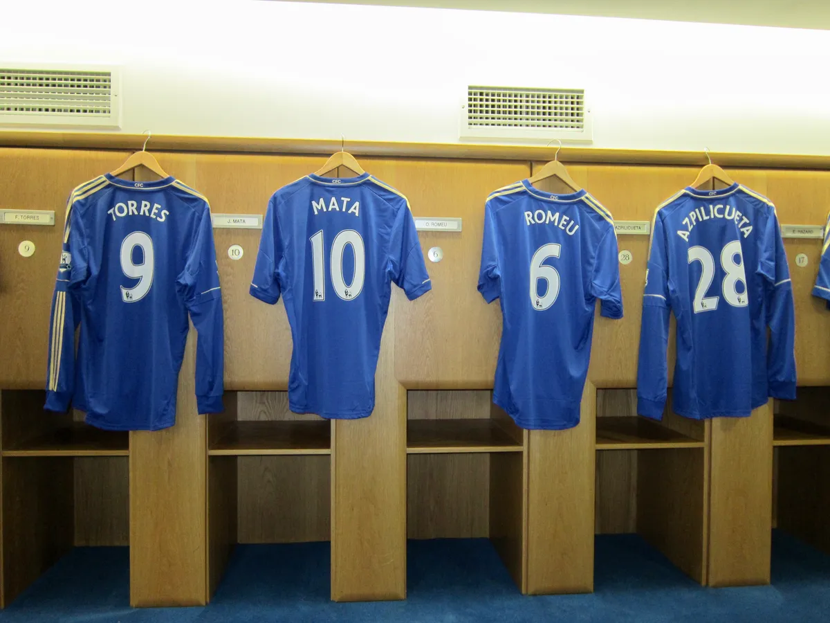 Row of Chelsea shirts above the dressing room benches on a Chelsea stadium tour in London